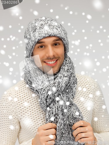 Image of handsome man in warm sweater, hat and scarf