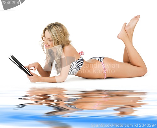 Image of woman in bikini with tablet pc computer