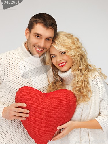 Image of family couple in a sweaters with heart