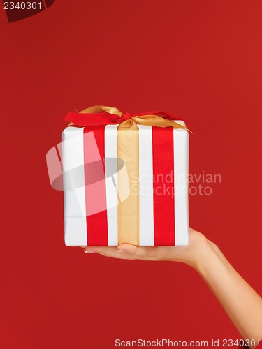 Image of woman's hands holding a gift box