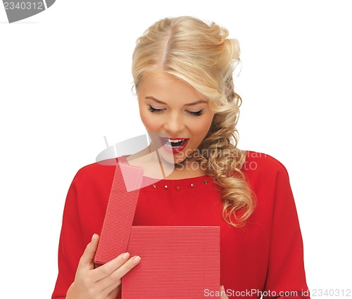 Image of lovely woman in red dress with opened gift box