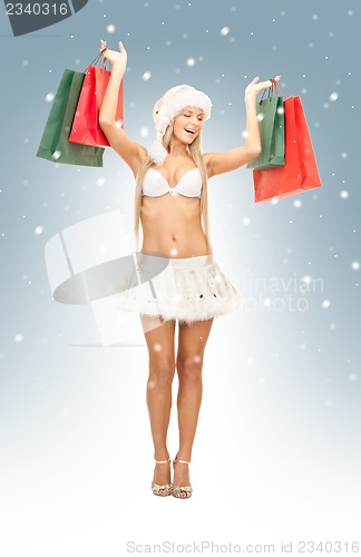Image of cheerful santa helper with shopping bags