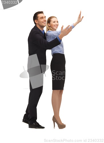 Image of man and woman making a greeting gesture