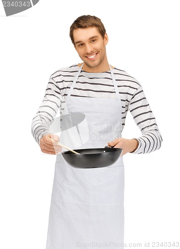 Image of handsome man with pan and spoon