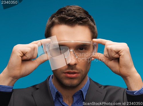 Image of businessman in protective glasses