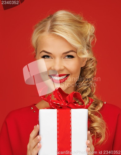 Image of lovely woman in red dress with present
