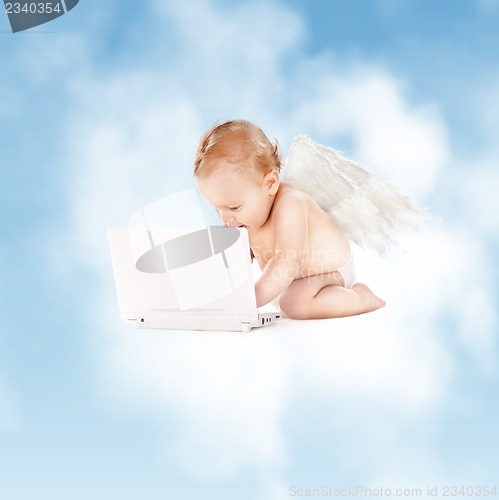 Image of little angel with laptop computer