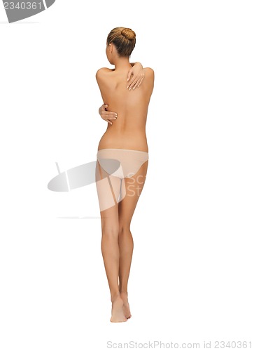 Image of rear view of beautiful topless woman in panties