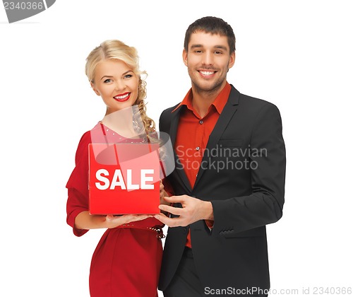 Image of man and woman with sale sign