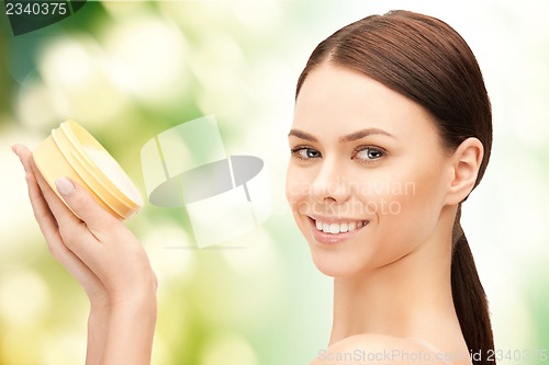 Image of beautiful woman with moisturizing creme