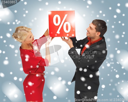 Image of man and woman with percent sign