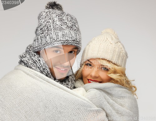 Image of family couple under warm blanket