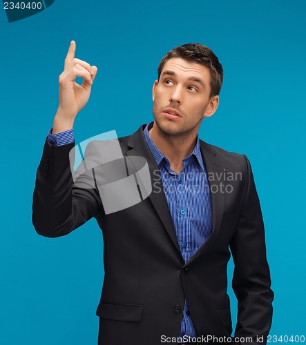 Image of man in suit with his finger up