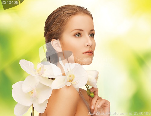 Image of beautiful woman with orchid flower