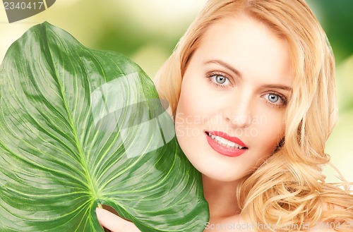 Image of woman with green leaf