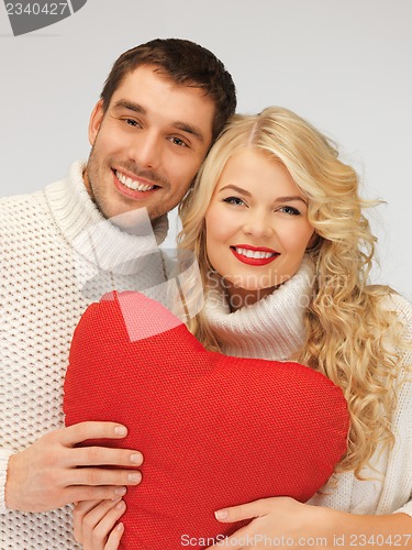 Image of family couple in a sweaters with heart