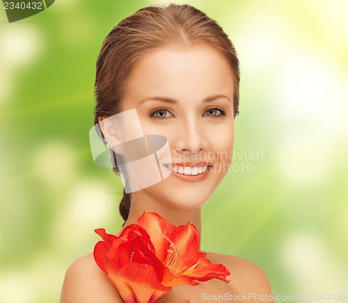 Image of lovely woman with red lily flower