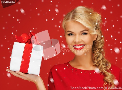 Image of lovely woman in red dress with present
