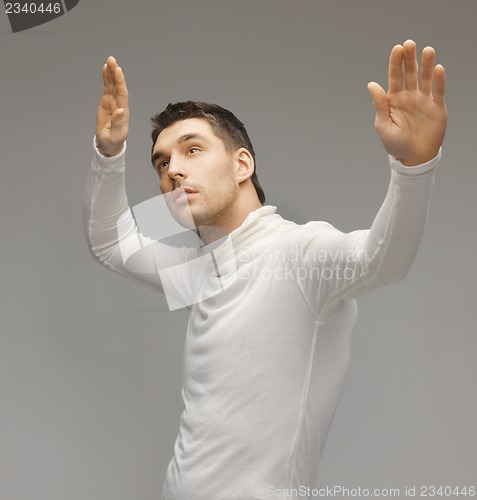 Image of man working with something imaginary