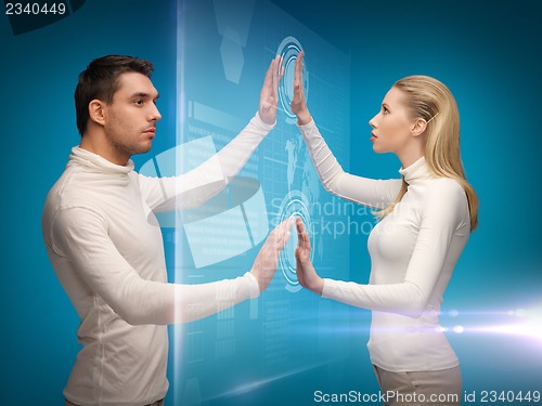 Image of man and woman working with virtual screens