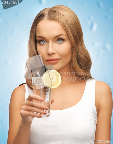 Image of woman with lemon slice on glass of water