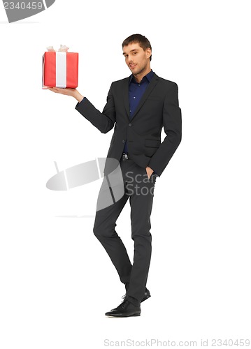 Image of handsome man in suit with a gift box