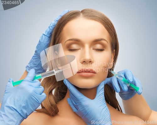 Image of woman face and beautician hands