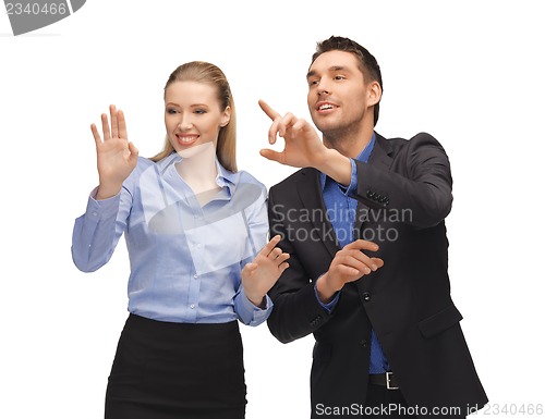 Image of man and woman working with something imaginary