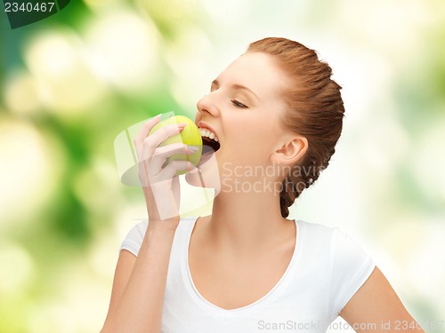 Image of young beautiful woman with green apple