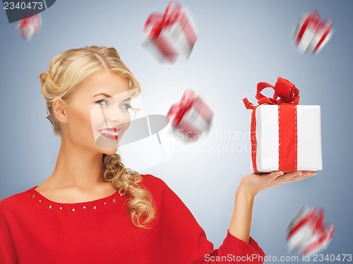 Image of lovely woman in red dress with present