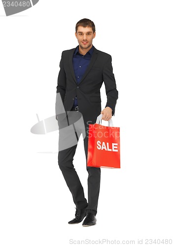 Image of handsome man in suit with sale sign