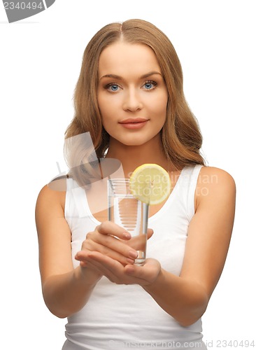 Image of woman with lemon slice on glass of water
