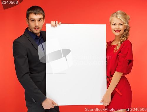 Image of couple holding big blank board