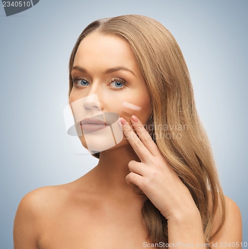 Image of woman applying foundation