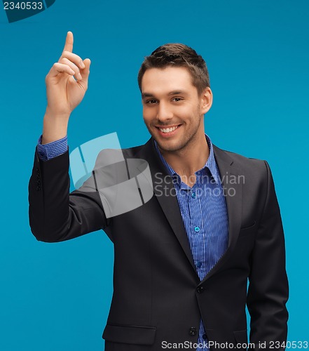 Image of man in suit with his finger up