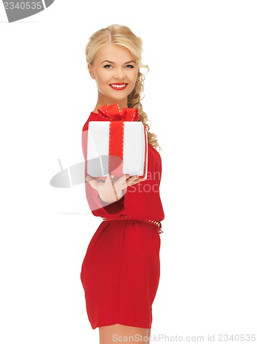 Image of lovely woman in red dress with present