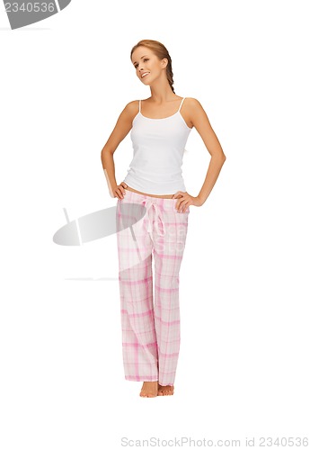 Image of happy and smiling woman in cotton pajamas