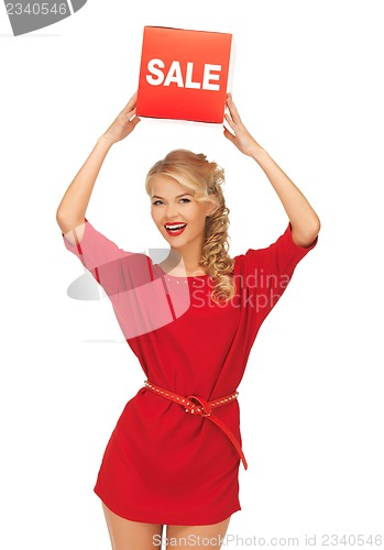 Image of lovely woman in red dress with sale sign
