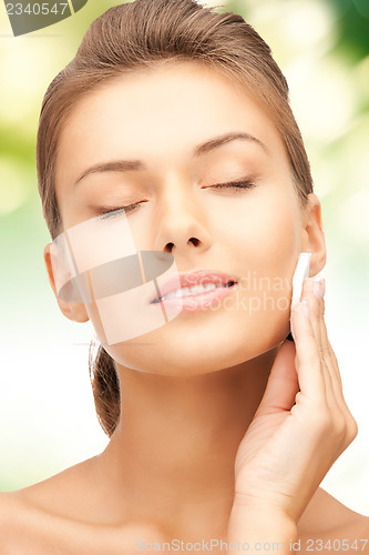 Image of beautiful woman with cotton pad