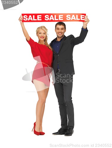 Image of man and woman with sale sign