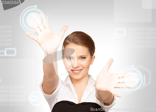 Image of businesswoman working with touch screen