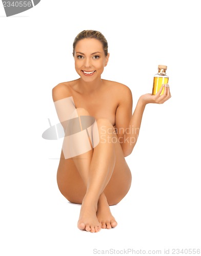 Image of healthy naked woman with oil bottle