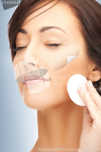 Image of beautiful woman with cotton pad