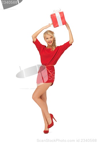 Image of lovely woman in red dress with present