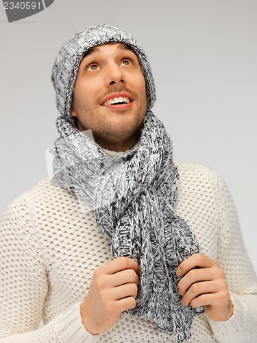 Image of handsome man in warm sweater, hat and scarf