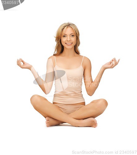 Image of woman practicing yoga lotus pose