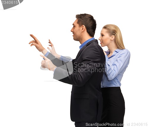 Image of man and woman working with something imaginary