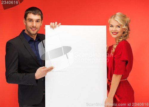 Image of couple holding big blank board