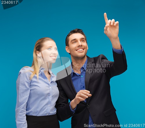 Image of man and woman working with something imaginary