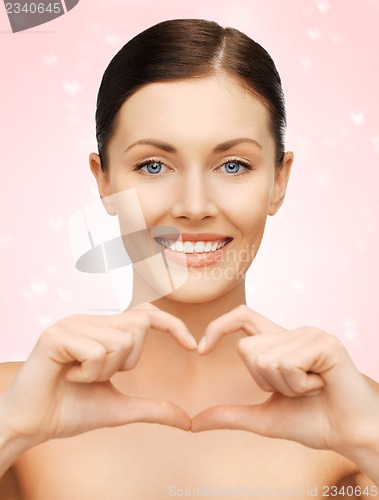 Image of woman showing heart shape